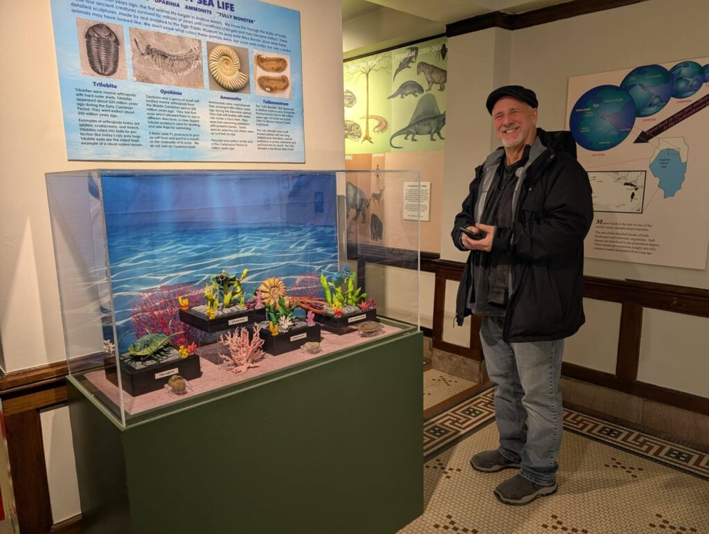 mike rende with the prehistoric creatures display in the elgin public museum 02